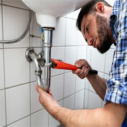 A plumber checks and prevents possible blocked drains